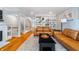 Bright living room featuring leather sofas, built-in shelves, and open access to the stairway at 536 Lockerbie S Cir, Indianapolis, IN 46202