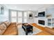 Inviting living room with a fireplace, comfortable leather seating, and bright natural light at 536 Lockerbie S Cir, Indianapolis, IN 46202