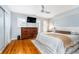 Comfortable primary bedroom with hardwood floors, modern decor, and a ceiling fan at 536 Lockerbie S Cir, Indianapolis, IN 46202
