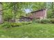 Expansive backyard with mature trees, deck, and lush landscaping, offering privacy at 577 Century Oaks Dr, Zionsville, IN 46077