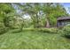 Well-maintained backyard with green grass, mature trees, and a charming deck area at 577 Century Oaks Dr, Zionsville, IN 46077