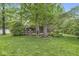 Lush backyard with a deck area, featuring mature trees for added privacy and beauty at 577 Century Oaks Dr, Zionsville, IN 46077
