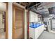 Unfinished basement area with cabinets, utility sink and blue countertops, ready for customization at 577 Century Oaks Dr, Zionsville, IN 46077