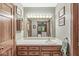 Neutral bathroom featuring a large mirror over vanity and an open doorway to bedroom at 577 Century Oaks Dr, Zionsville, IN 46077