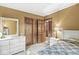 Bedroom with a closet, white dresser, and bed with blue patterned bedding at 577 Century Oaks Dr, Zionsville, IN 46077