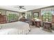Bedroom with a ceiling fan, large windows and traditional wood furniture at 577 Century Oaks Dr, Zionsville, IN 46077