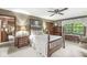 Charming bedroom with a four-poster bed, wood accents, and a window with a view at 577 Century Oaks Dr, Zionsville, IN 46077