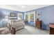 Light blue bedroom showcasing a white bed, desk, and three sunny windows at 577 Century Oaks Dr, Zionsville, IN 46077