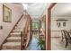 Inviting entryway with slate floors, carpeted stairs and wood trim at 577 Century Oaks Dr, Zionsville, IN 46077