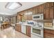 Bright kitchen with wooden cabinets, white countertops, and breakfast nook access at 577 Century Oaks Dr, Zionsville, IN 46077