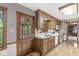 Functional kitchen with wooden cabinets, white appliances, and a door to the backyard at 577 Century Oaks Dr, Zionsville, IN 46077