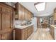 Charming kitchen with wooden cabinets, checkered wallpaper, and modern appliances at 577 Century Oaks Dr, Zionsville, IN 46077