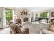 Spacious living room with fireplace, piano, and large windows overlooking the greenery at 577 Century Oaks Dr, Zionsville, IN 46077