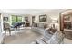 Bright living room with a piano, fireplace, and large windows that flood the space with natural light at 577 Century Oaks Dr, Zionsville, IN 46077