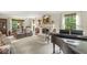 Bright living room with a fireplace, large windows, and a grand piano at 577 Century Oaks Dr, Zionsville, IN 46077