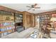Wood-paneled living room featuring built-in bookshelves, a TV, and a view into the kitchen at 577 Century Oaks Dr, Zionsville, IN 46077