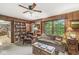 Comfortable living room with wood paneling, bookshelves, and views of the backyard at 577 Century Oaks Dr, Zionsville, IN 46077