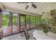 Inviting screened porch with ceiling fan, outdoor furniture, and serene views of the wooded backyard at 577 Century Oaks Dr, Zionsville, IN 46077