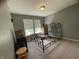 A sparsely furnished bedroom featuring a metal bed frame and a window at 5920 Copeland Mills Dr, Indianapolis, IN 46221