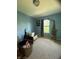 An empty bedroom with blue walls and a window at 5920 Copeland Mills Dr, Indianapolis, IN 46221