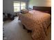 Bedroom with a large window and carpeted floors, showing a cozy residential space at 5920 Copeland Mills Dr, Indianapolis, IN 46221