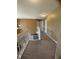 Upstairs hallway with tan walls, white banister, and neutral carpet at 5920 Copeland Mills Dr, Indianapolis, IN 46221