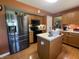 Well-equipped kitchen with stainless steel appliances, wood cabinets, countertops, and a center island at 5920 Copeland Mills Dr, Indianapolis, IN 46221
