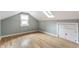 Finished attic bedroom featuring wood floors and built-in storage at 595 W Poplar St, Zionsville, IN 46077