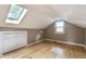 Finished attic bedroom with hardwood floors, window, and skylight providing ample natural light at 595 W Poplar St, Zionsville, IN 46077
