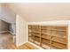 Finished attic featuring wood floor and built-in shelving at 595 W Poplar St, Zionsville, IN 46077