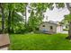 Well-manicured backyard featuring a lush green lawn, a detached garage and mature trees providing shade at 595 W Poplar St, Zionsville, IN 46077