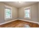 Bedroom with hardwood floors, neutral walls, and natural light from multiple windows at 595 W Poplar St, Zionsville, IN 46077
