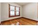 Small bedroom showcasing hardwood floors, neutral paint, and natural light from large windows at 595 W Poplar St, Zionsville, IN 46077