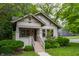 Attractive residence showcases a welcoming front porch and manicured bushes, creating a cozy curb appeal at 595 W Poplar St, Zionsville, IN 46077