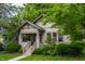 A beautiful house with a covered porch, complemented by a well-maintained lawn and mature trees at 595 W Poplar St, Zionsville, IN 46077