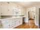 Charming kitchen with white cabinetry, stainless steel appliances and hardwood floors at 595 W Poplar St, Zionsville, IN 46077