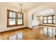 Bright living room featuring hardwood floors, large windows with blinds, and archway to another room at 595 W Poplar St, Zionsville, IN 46077