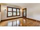 Bright living room with beautiful hardwood floors, wooden trim, and an abundance of natural light at 595 W Poplar St, Zionsville, IN 46077