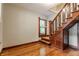Classic staircase with wooden railings and hardwood floors leading to upper level at 595 W Poplar St, Zionsville, IN 46077