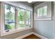 Sun room featuring large windows with tree views, hardwood floors, and neutral paint at 595 W Poplar St, Zionsville, IN 46077