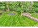 Aerial view showcasing a spacious backyard with a playground, firepit, and steps leading to the yard at 6168 Pine Bluff Dr, Avon, IN 46123