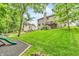 Spacious backyard featuring a lawn, trees, and a ' slide, great for outdoor fun at 6168 Pine Bluff Dr, Avon, IN 46123