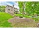 Large backyard with fire pit, playground, and a hillside stairway leading up to a two-story house at 6168 Pine Bluff Dr, Avon, IN 46123