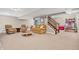 Finished basement with comfortable seating, plush carpeting, and a staircase to the upper level at 6168 Pine Bluff Dr, Avon, IN 46123