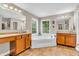 Spacious primary bathroom features a soaking tub, dual vanities, and tile floors at 6168 Pine Bluff Dr, Avon, IN 46123