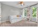 Bright bedroom with ceiling fan, white trim, and ample natural light at 6168 Pine Bluff Dr, Avon, IN 46123