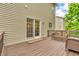 Outdoor deck with a view of the side yard featuring a wicker bench and chairs for relaxation and enjoyment at 6168 Pine Bluff Dr, Avon, IN 46123