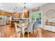 Dining area with hardwood floors, an adjacent kitchen, and a door leading to a porch at 6168 Pine Bluff Dr, Avon, IN 46123