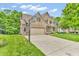 Well-maintained brick home with an attached garage and spacious driveway at 6168 Pine Bluff Dr, Avon, IN 46123