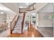 Grand foyer features a staircase with wood and iron railings and views into dining and living areas at 6168 Pine Bluff Dr, Avon, IN 46123